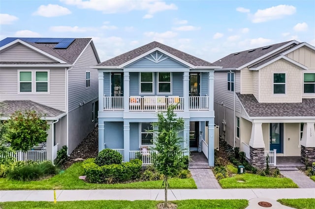 15133 Summer Harvest St, Winter Garden, FL 34787 - view of front facade with a porch, a balcony, roof with shingles, and stucco siding