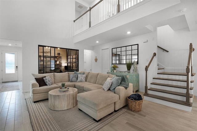 15133 Summer Harvest St, Winter Garden, FL 34787 - living room featuring wood finished floors, stairs, a high ceiling, and recessed lighting