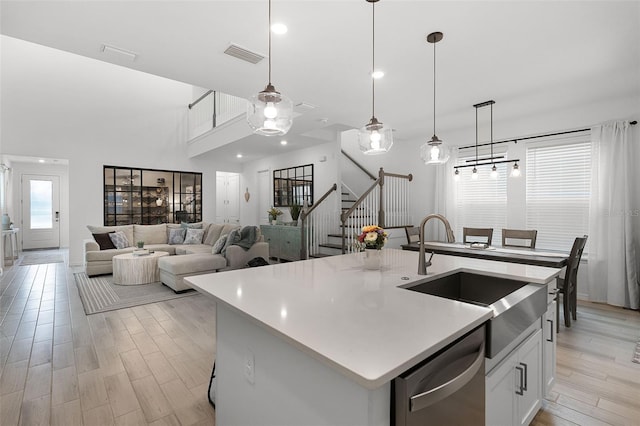 15133 Summer Harvest St, Winter Garden, FL 34787 - kitchen with stainless steel dishwasher, light countertops, light wood-style flooring, hanging light fixtures, and recessed lighting