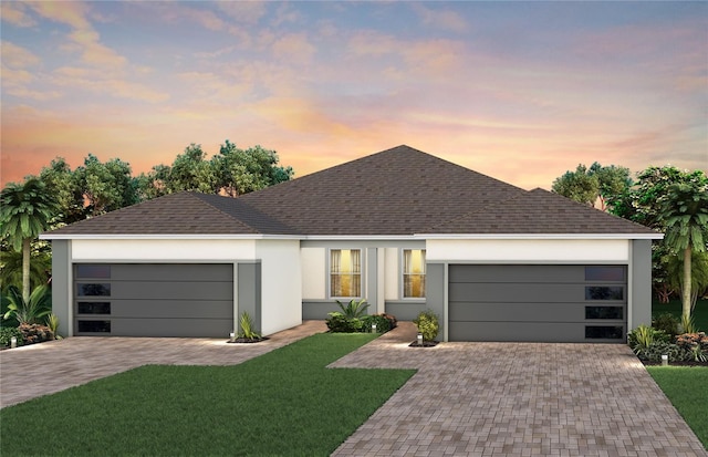13533 Pearl Beach St, Winter Garden, FL 34787 - ranch-style house featuring a garage, decorative driveway, a front yard, and a shingled roof