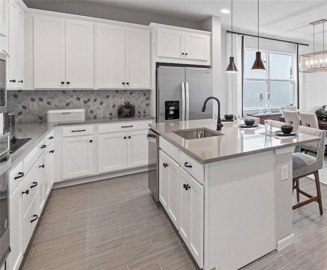 4409 Lions Gate Ave, Clermont, FL 34711 - kitchen with appliances with stainless steel finishes, decorative backsplash, recessed lighting, light countertops, and white cabinetry