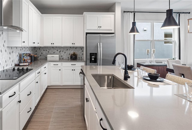 4409 Lions Gate Ave, Clermont, FL 34711 - kitchen with extractor fan, appliances with stainless steel finishes, white cabinetry, decorative light fixtures, and decorative backsplash