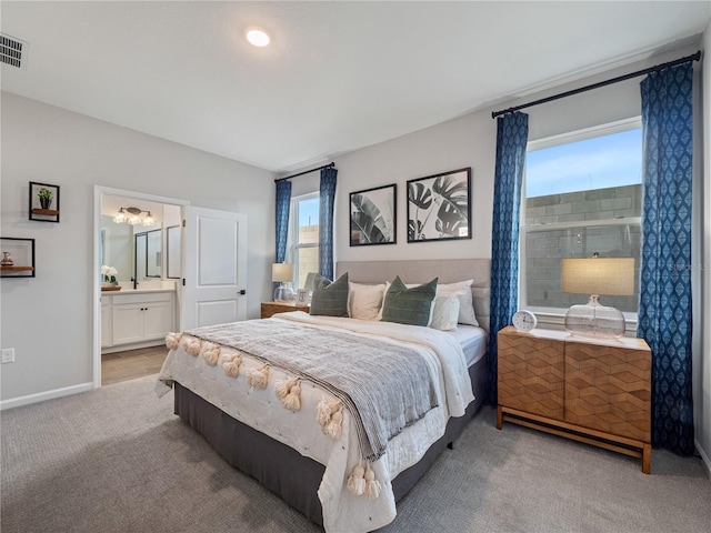 4409 Lions Gate Ave, Clermont, FL 34711 - bedroom featuring light colored carpet, ensuite bath, and a chandelier