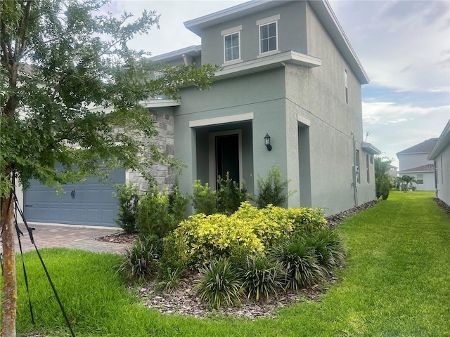 4409 Lions Gate Ave, Clermont, FL 34711 - view of front of house featuring stucco siding, a garage, a front lawn, and stone siding