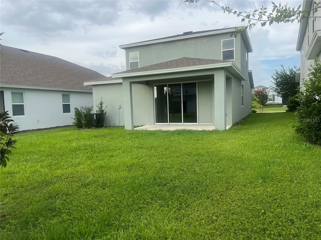 4409 Lions Gate Ave, Clermont, FL 34711 - back of property with stucco siding, a yard, and a shingled roof