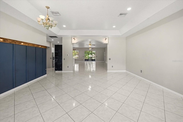 13848 Vista Del Lago Blvd, Clermont, FL 34711 - empty room with light tile patterned flooring, a chandelier, arched walkways, a raised ceiling, and recessed lighting