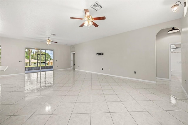 13848 Vista Del Lago Blvd, Clermont, FL 34711 - unfurnished room with ceiling fan, arched walkways, and light tile patterned flooring