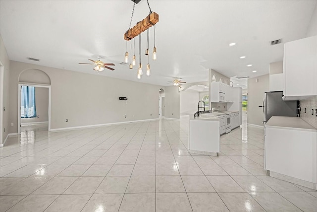 13848 Vista Del Lago Blvd, Clermont, FL 34711 - kitchen with a ceiling fan, freestanding refrigerator, open floor plan, light tile patterned flooring, and light countertops