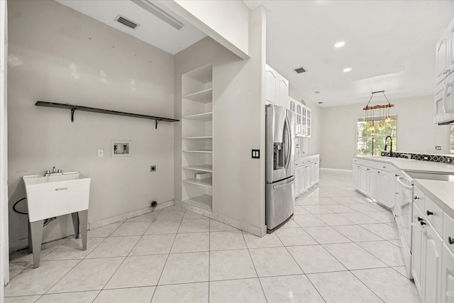 13848 Vista Del Lago Blvd, Clermont, FL 34711 - kitchen featuring stainless steel refrigerator with ice dispenser, white cabinets, recessed lighting, a chandelier, and light tile patterned floors