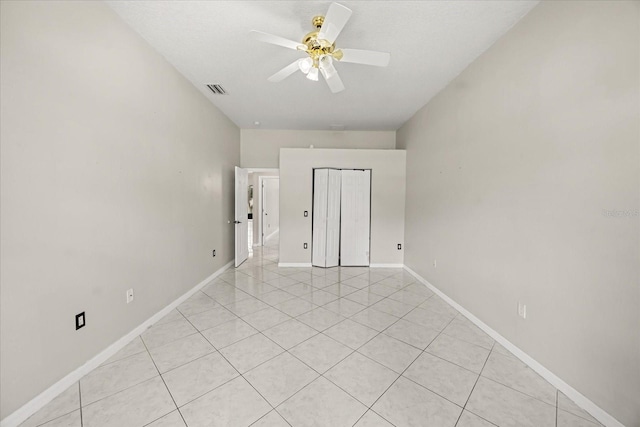 13848 Vista Del Lago Blvd, Clermont, FL 34711 - unfurnished bedroom featuring light tile patterned floors, a closet, and ceiling fan