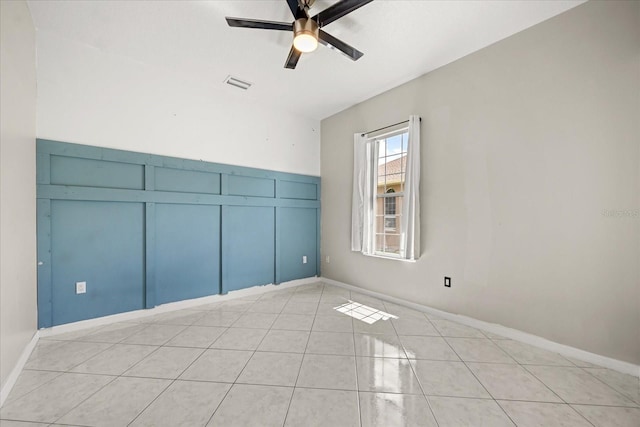 13848 Vista Del Lago Blvd, Clermont, FL 34711 - unfurnished room featuring a ceiling fan, light tile patterned floors, and a decorative wall