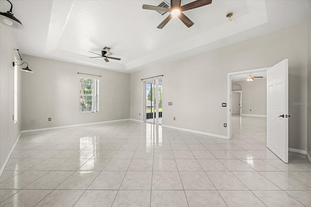 13848 Vista Del Lago Blvd, Clermont, FL 34711 - spare room featuring ceiling fan, a tray ceiling, and light tile patterned floors