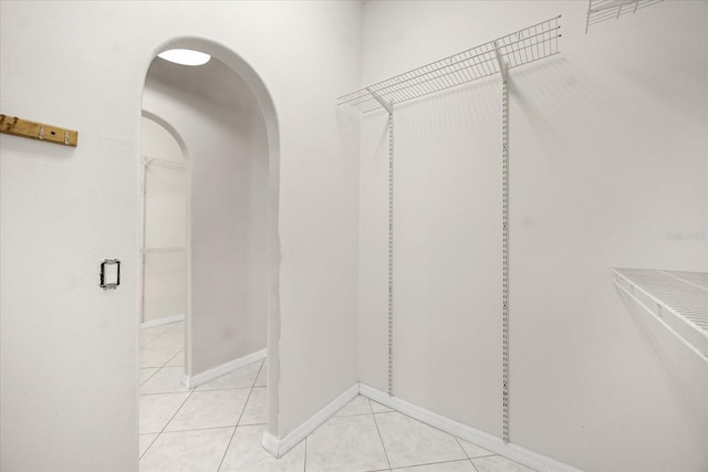 13848 Vista Del Lago Blvd, Clermont, FL 34711 - walk in closet with arched walkways and light tile patterned floors