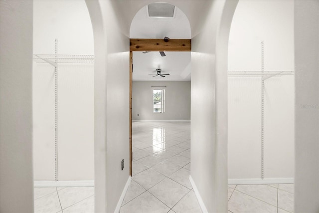 13848 Vista Del Lago Blvd, Clermont, FL 34711 - hall with light tile patterned floors, beamed ceiling, and arched walkways