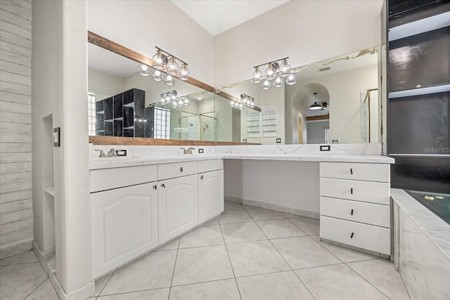 13848 Vista Del Lago Blvd, Clermont, FL 34711 - bathroom featuring double vanity, tile patterned floors, a chandelier, and a bathtub