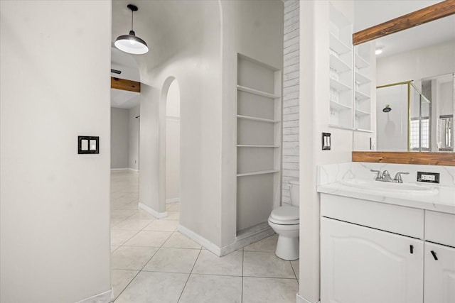 13848 Vista Del Lago Blvd, Clermont, FL 34711 - bathroom with built in shelves, a shower stall, vanity, and tile patterned floors
