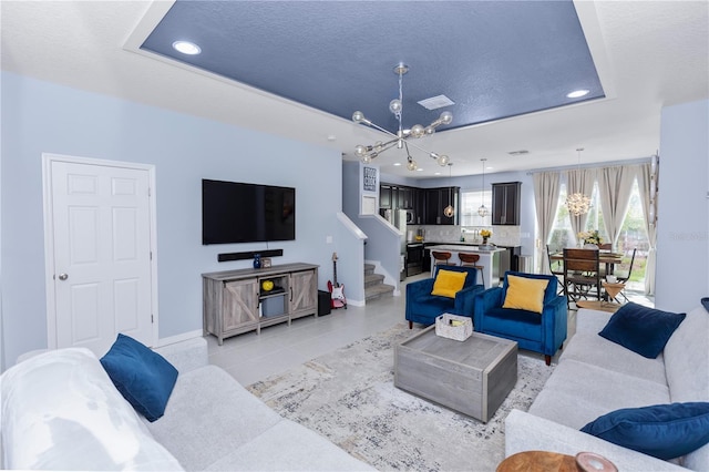 4733 Cliveden Loop, Sanford, FL 32773 - living area featuring a chandelier, recessed lighting, stairs, light tile patterned floors, and a raised ceiling