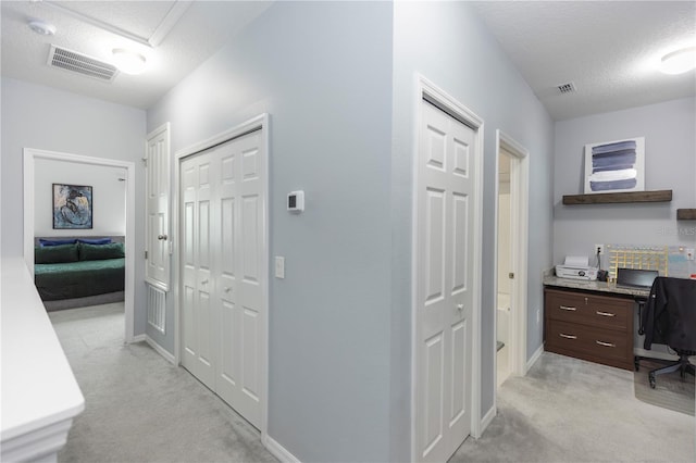 4733 Cliveden Loop, Sanford, FL 32773 - hallway with light colored carpet, a desk, and a textured ceiling