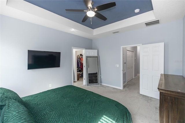 4733 Cliveden Loop, Sanford, FL 32773 - bedroom featuring a raised ceiling, carpet floors, a spacious closet, and a ceiling fan