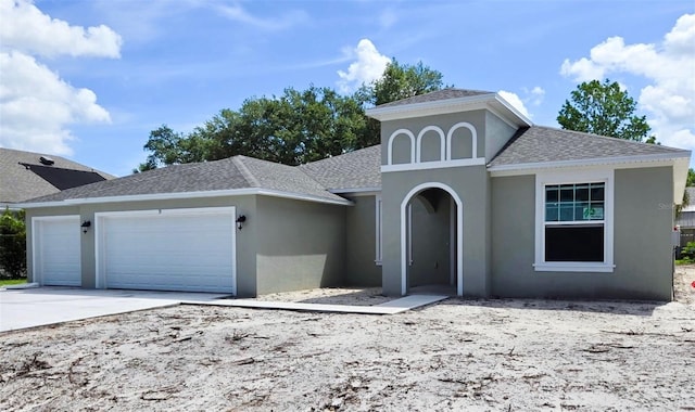 55 Sea Breeze Trl, Palm Coast, FL 32164 - view of front of home featuring a shingled roof, a garage, stucco siding, and concrete driveway