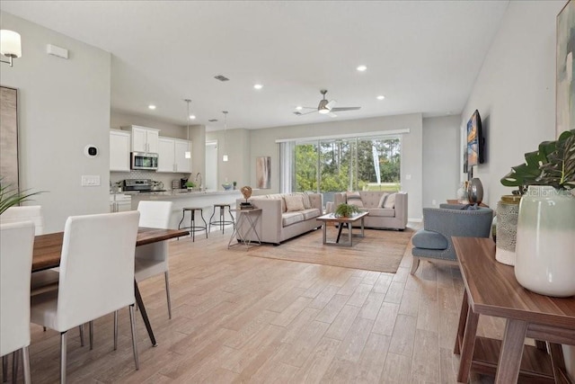 55 Sea Breeze Trl, Palm Coast, FL 32164 - living area with light wood-type flooring, ceiling fan, and recessed lighting