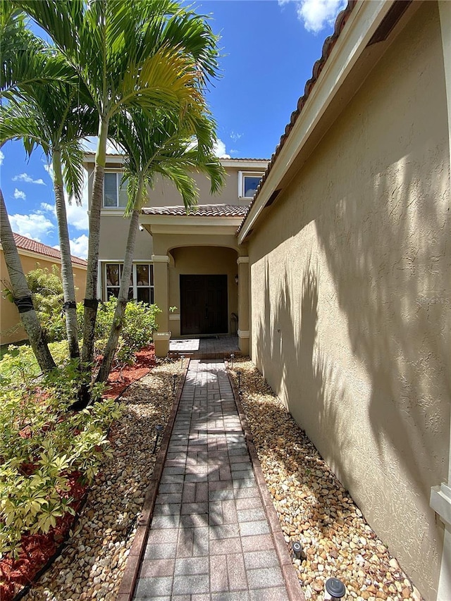 4375 Foxtail Ln, Weston, FL 33331 - view of exterior entry with stucco siding and a tiled roof
