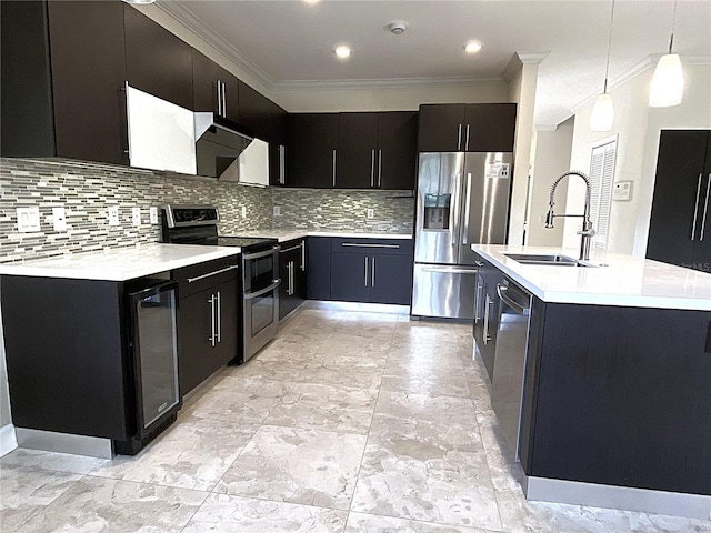 4375 Foxtail Ln, Weston, FL 33331 - kitchen with stainless steel appliances, crown molding, dark cabinetry, light countertops, and pendant lighting