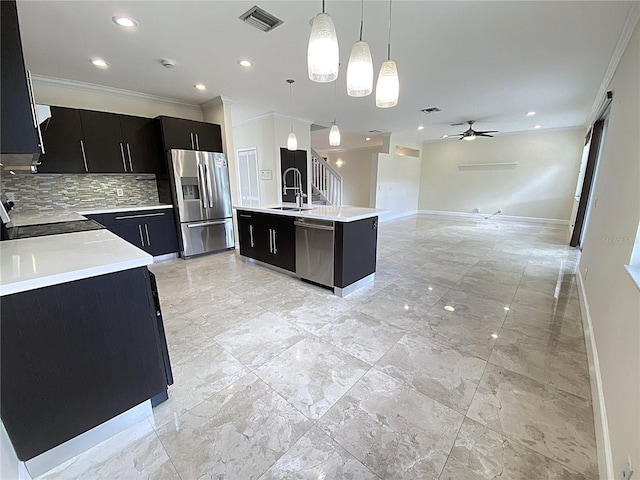 4375 Foxtail Ln, Weston, FL 33331 - kitchen with dark cabinetry, stainless steel appliances, ornamental molding, ceiling fan, and light countertops