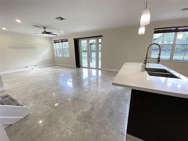 4375 Foxtail Ln, Weston, FL 33331 - kitchen featuring ornamental molding, light marble finish flooring, ceiling fan, light countertops, and decorative light fixtures