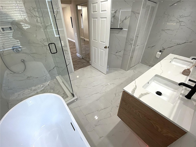 4375 Foxtail Ln, Weston, FL 33331 - bathroom featuring double vanity, a freestanding bath, a marble finish shower, a closet, and marble tiled flooring
