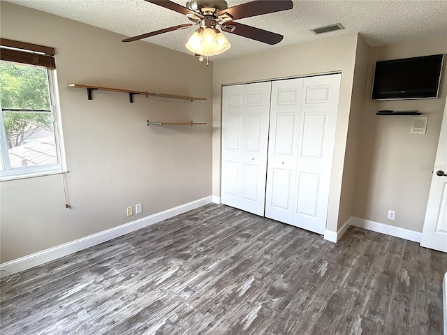 4375 Foxtail Ln, Weston, FL 33331 - unfurnished bedroom featuring dark wood-type flooring, a textured ceiling, a closet, and ceiling fan