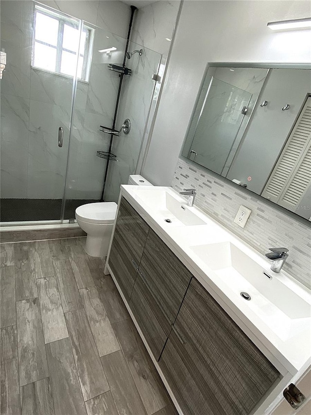 4375 Foxtail Ln, Weston, FL 33331 - full bathroom with a marble finish shower, double vanity, wood finished floors, and tasteful backsplash