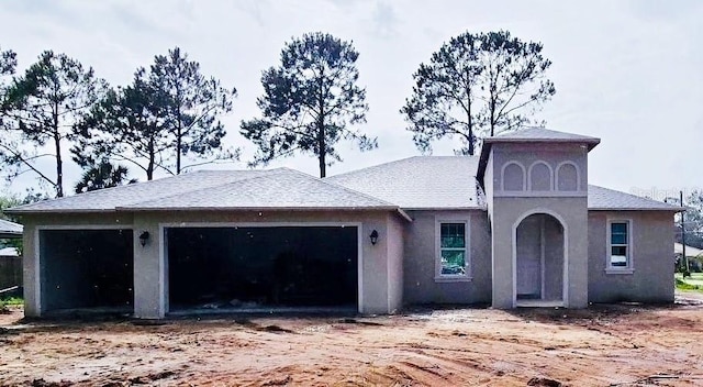 27 Pier Ln, Palm Coast, FL 32164 - view of front of house featuring a garage and stucco siding