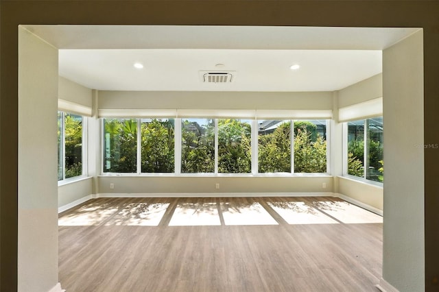 2895 Apache Ct, The Villages, FL 32163 - empty room with wood finished floors, healthy amount of natural light, and recessed lighting