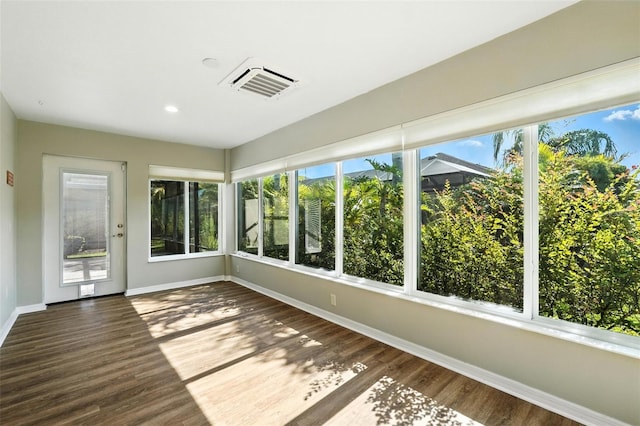 2895 Apache Ct, The Villages, FL 32163 - unfurnished sunroom with wood finished floors and recessed lighting