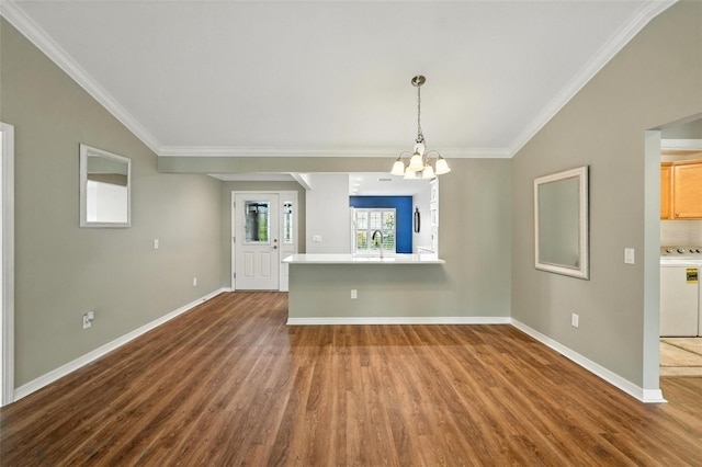 2895 Apache Ct, The Villages, FL 32163 - unfurnished dining area with dark wood-style flooring, washer / clothes dryer, a chandelier, and ornamental molding