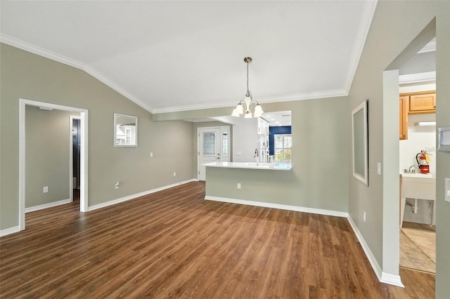 2895 Apache Ct, The Villages, FL 32163 - unfurnished living room with dark wood-type flooring, a chandelier, crown molding, and lofted ceiling