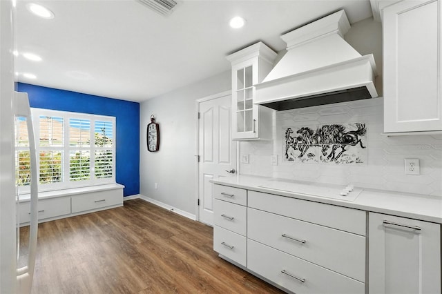 2895 Apache Ct, The Villages, FL 32163 - kitchen featuring custom range hood, stovetop, backsplash, recessed lighting, and white cabinets