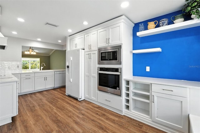 2895 Apache Ct, The Villages, FL 32163 - kitchen with appliances with stainless steel finishes, open shelves, white cabinets, dark wood-style floors, and recessed lighting