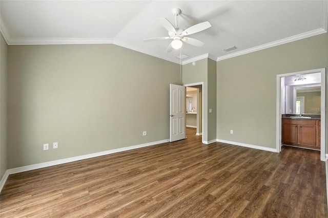2895 Apache Ct, The Villages, FL 32163 - unfurnished bedroom with dark wood finished floors, crown molding, ensuite bathroom, vaulted ceiling, and ceiling fan