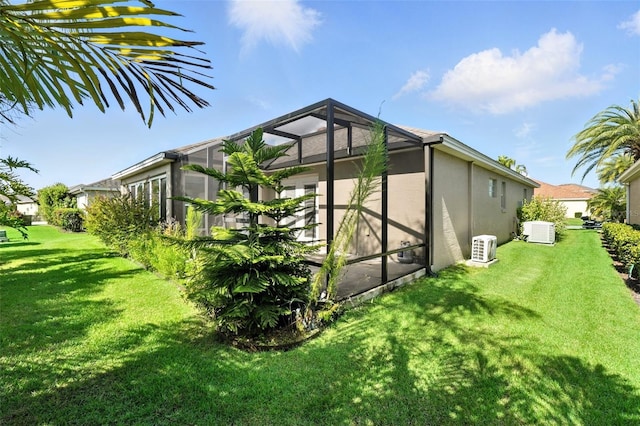 2895 Apache Ct, The Villages, FL 32163 - view of side of property featuring stucco siding, a yard, and a lanai