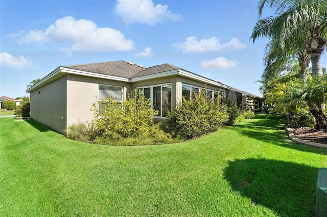 2895 Apache Ct, The Villages, FL 32163 - rear view of property featuring a lawn and stucco siding