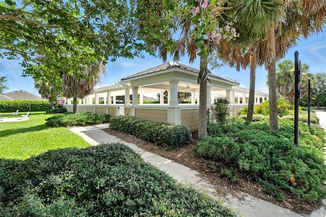 2895 Apache Ct, The Villages, FL 32163 - view of property exterior featuring a yard, mail area, a gazebo, a standing seam roof, and a metal roof