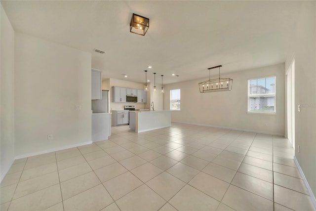 2601 Blowing Breeze Ave, Kissimmee, FL 34744 - unfurnished living room featuring light tile patterned floors, a chandelier, and recessed lighting