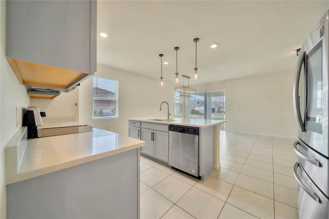 2601 Blowing Breeze Ave, Kissimmee, FL 34744 - kitchen featuring appliances with stainless steel finishes, light countertops, decorative light fixtures, recessed lighting, and light tile patterned flooring