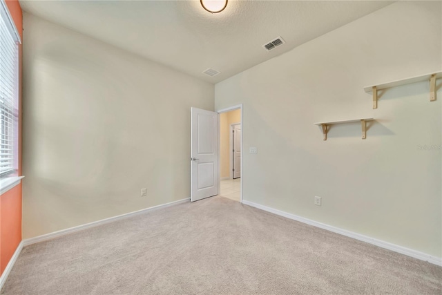 2601 Blowing Breeze Ave, Kissimmee, FL 34744 - spare room featuring light carpet and baseboards