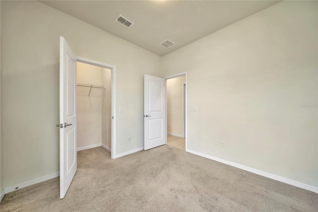 2601 Blowing Breeze Ave, Kissimmee, FL 34744 - unfurnished bedroom featuring light carpet, a spacious closet, and a closet