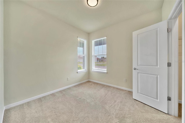 2601 Blowing Breeze Ave, Kissimmee, FL 34744 - spare room with light carpet and baseboards