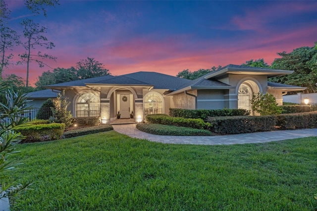 5102 Round Tree Ct, Orlando, FL 32819 - view of front facade with stucco siding and a yard