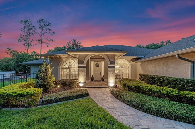 5102 Round Tree Ct, Orlando, FL 32819 - view of front of house with stucco siding and roof with shingles